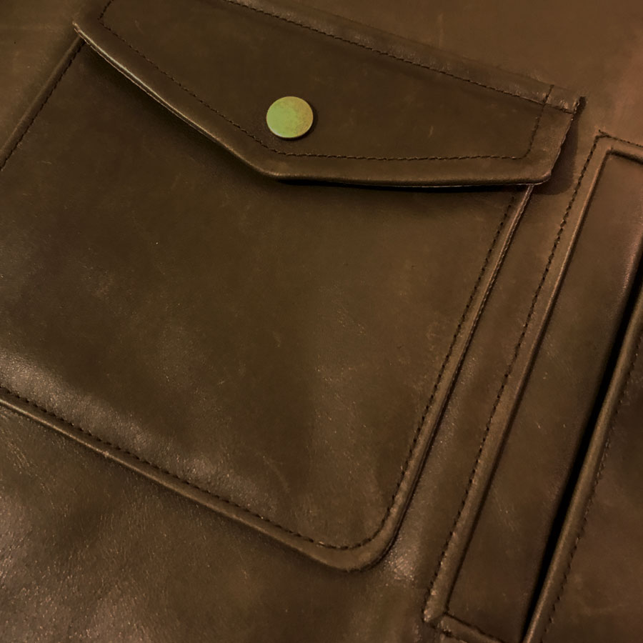 detail of welt and patch pockets on captain marvel jacket